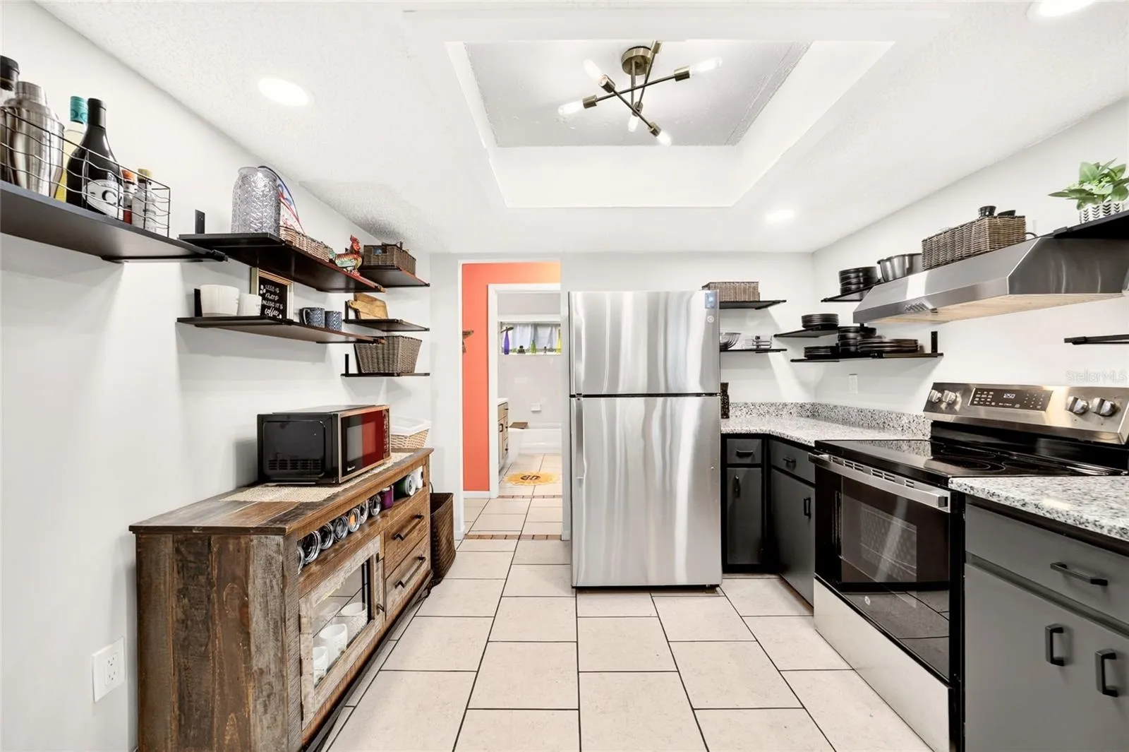 Keep it minimalist or room to add more cabinets. This functional kitchen has more storage than you notice. Keeping it airy and inviting. Lots of extra light with new LEDs in the ceiling