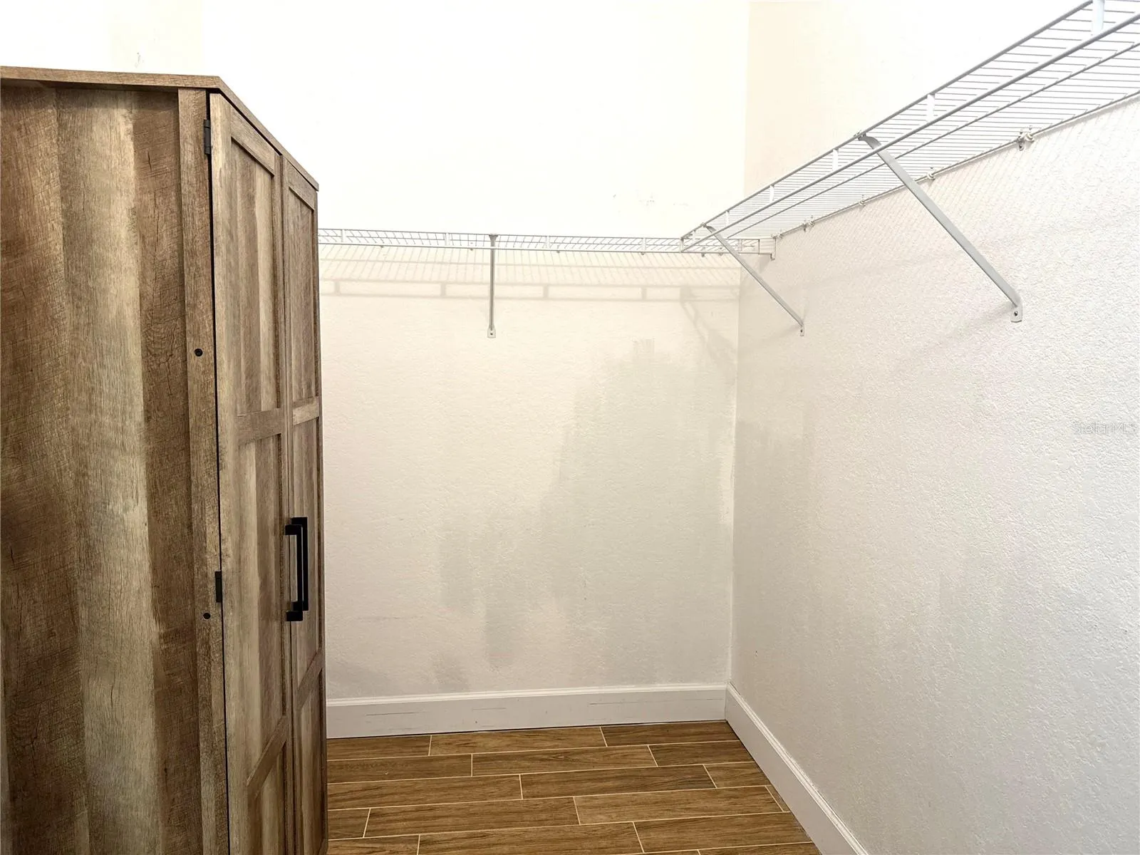 Primary bedroom walk-in closet