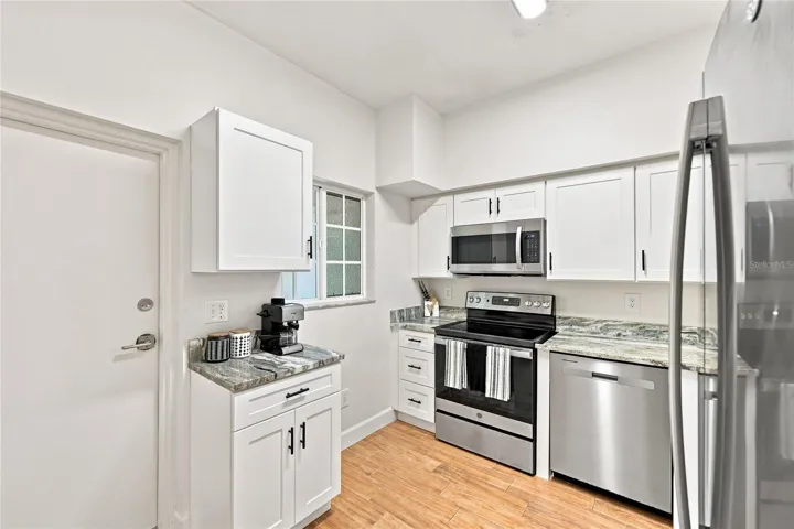 Kitchen with window for natural light and entry to screened lanai