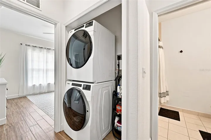 Laundry in private guest hallway with a pocket door for privacy