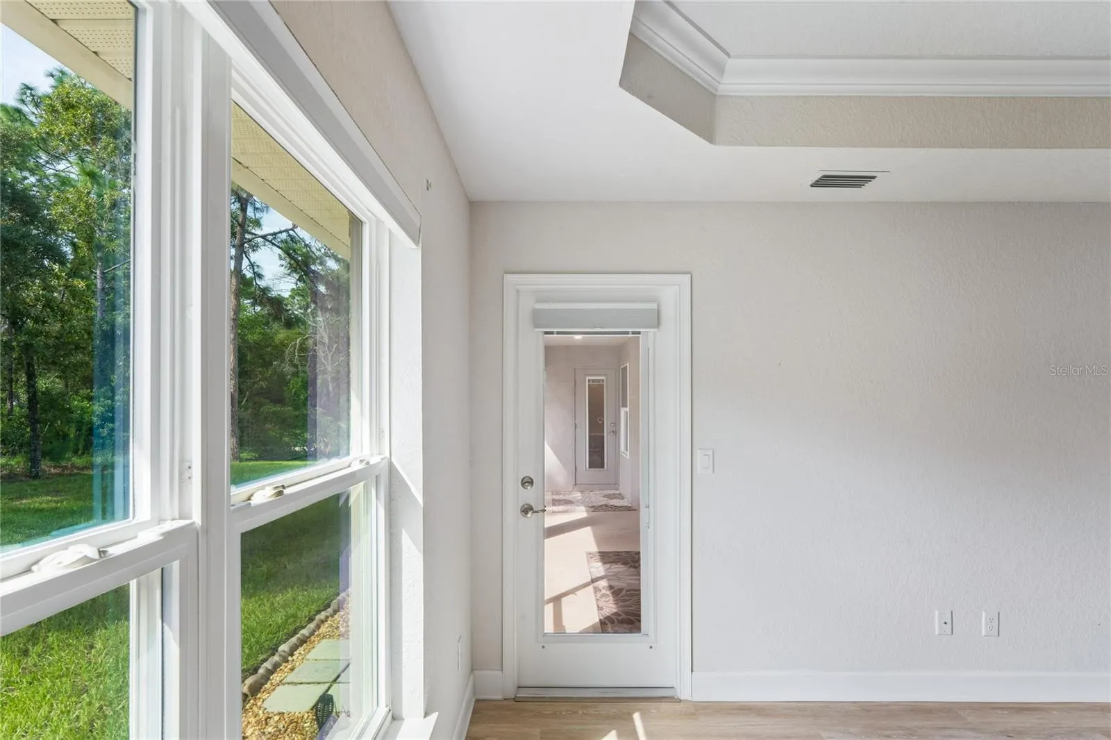 Primary Bedroom suite leading to screened lanai