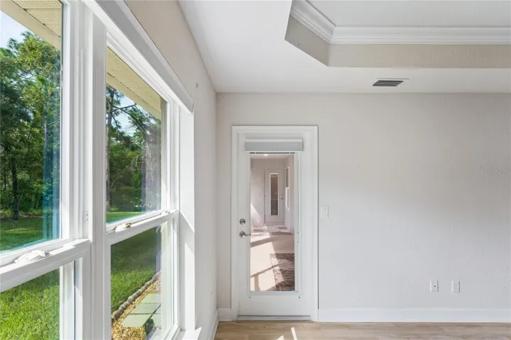 Primary Bedroom suite leading to screened lanai