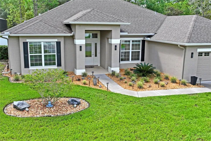 Landscaping package includes new front planter, tree, solar lighting, lighted house number, large rocks and beds with rocks all around house!!