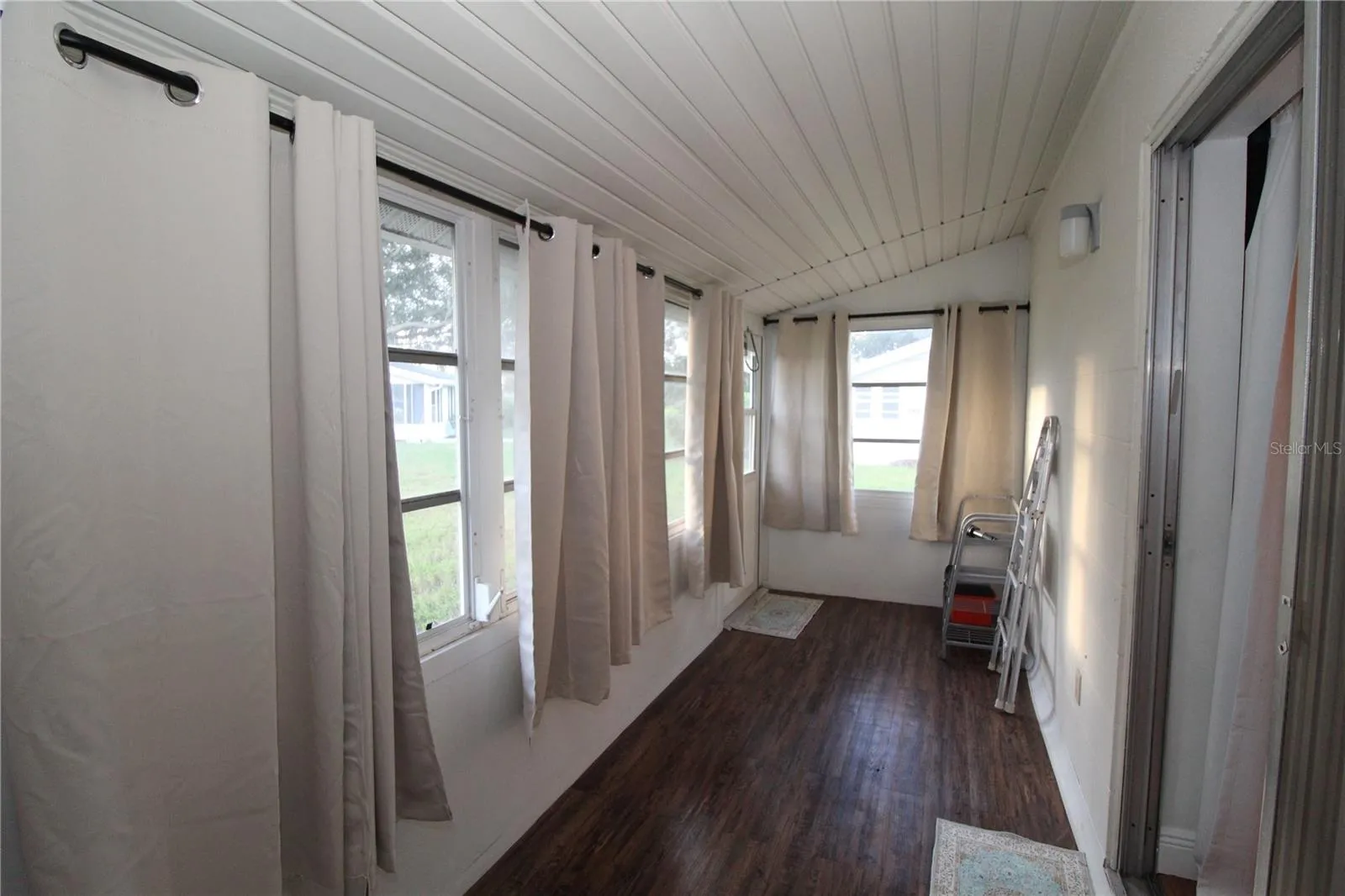 Sliding glass doors in the bedroom lead to an enclosed lanai.  Perfect place for morning coffee with a quiet courtyard view.