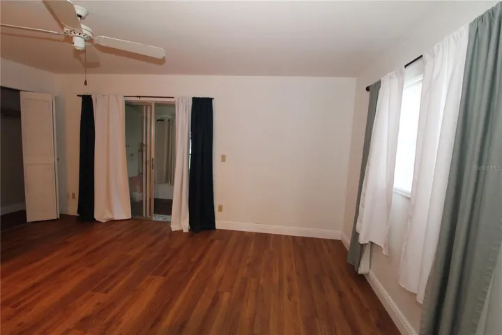 Primary bedroom with sliding glass doors to the covered lanai.