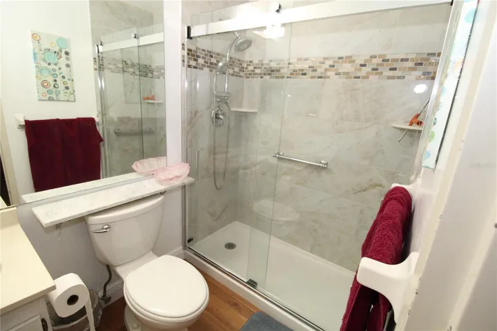 Primary bathroom with beautiful step in shower.  Updated shower doors and tile add style and elegance.