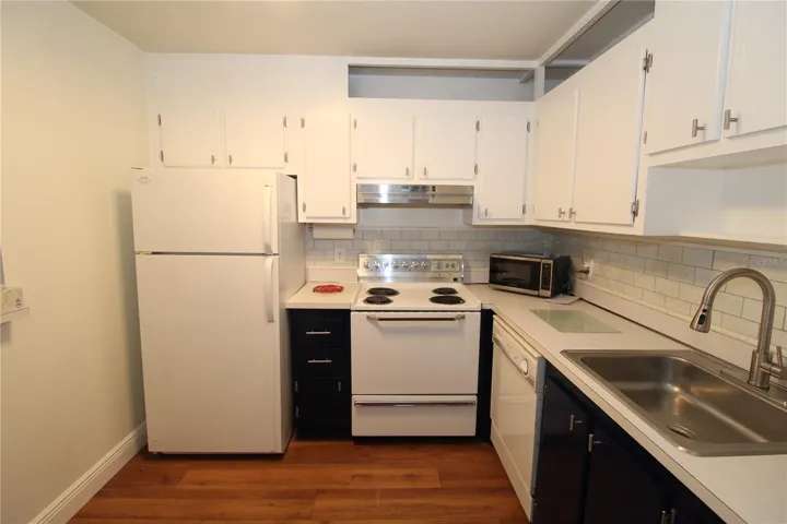 Kitchen is pretty and bright, plenty of cabinet space.