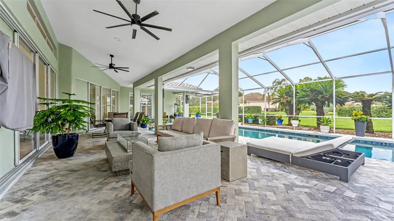 Large screened lanai overlooking saltwater pool with plenty of room for entertaining and sunbathing