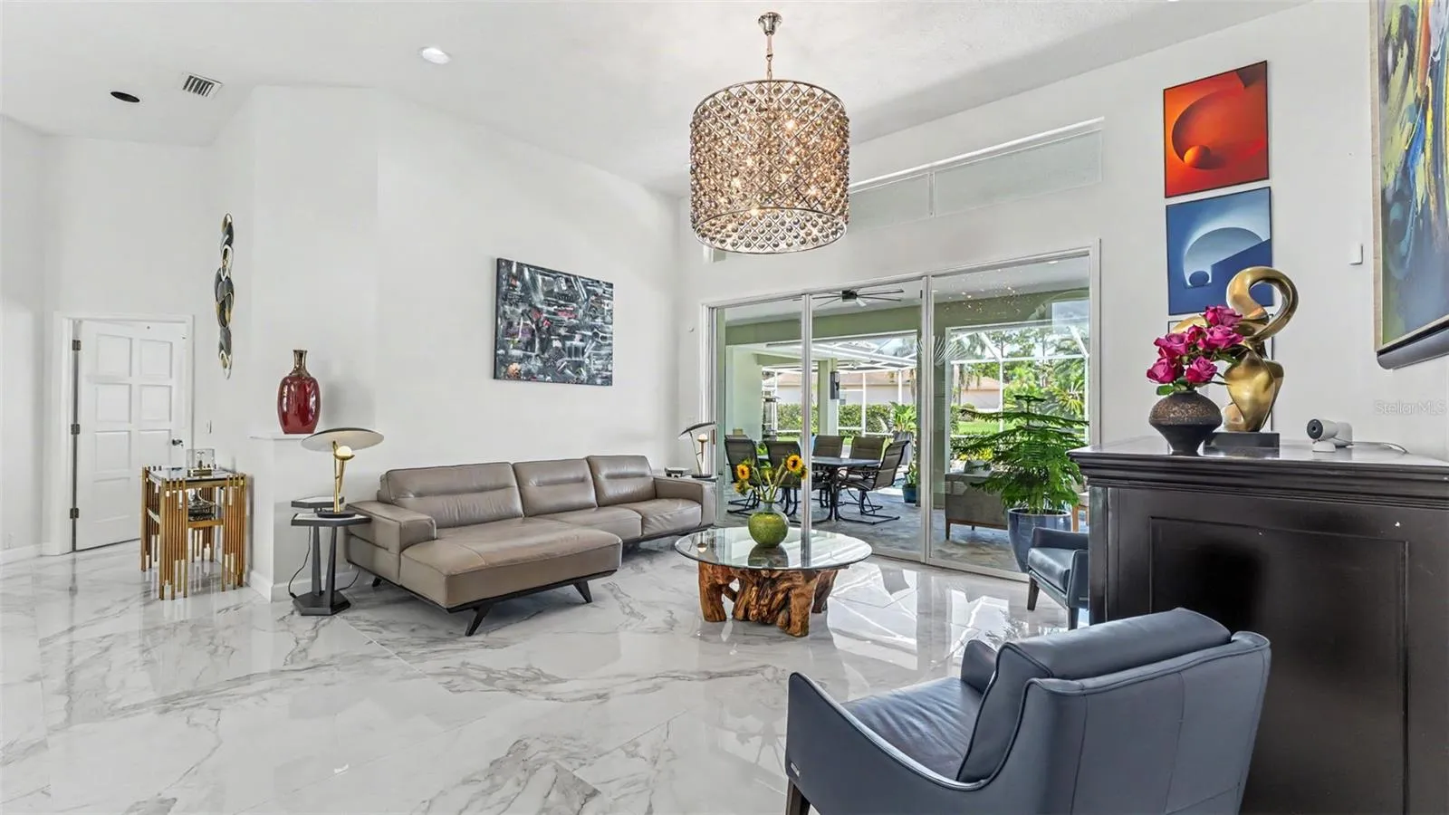 The Living Room has a nice airy feeling and features volume ceilings, tile floors, sliders leading out to the pool area