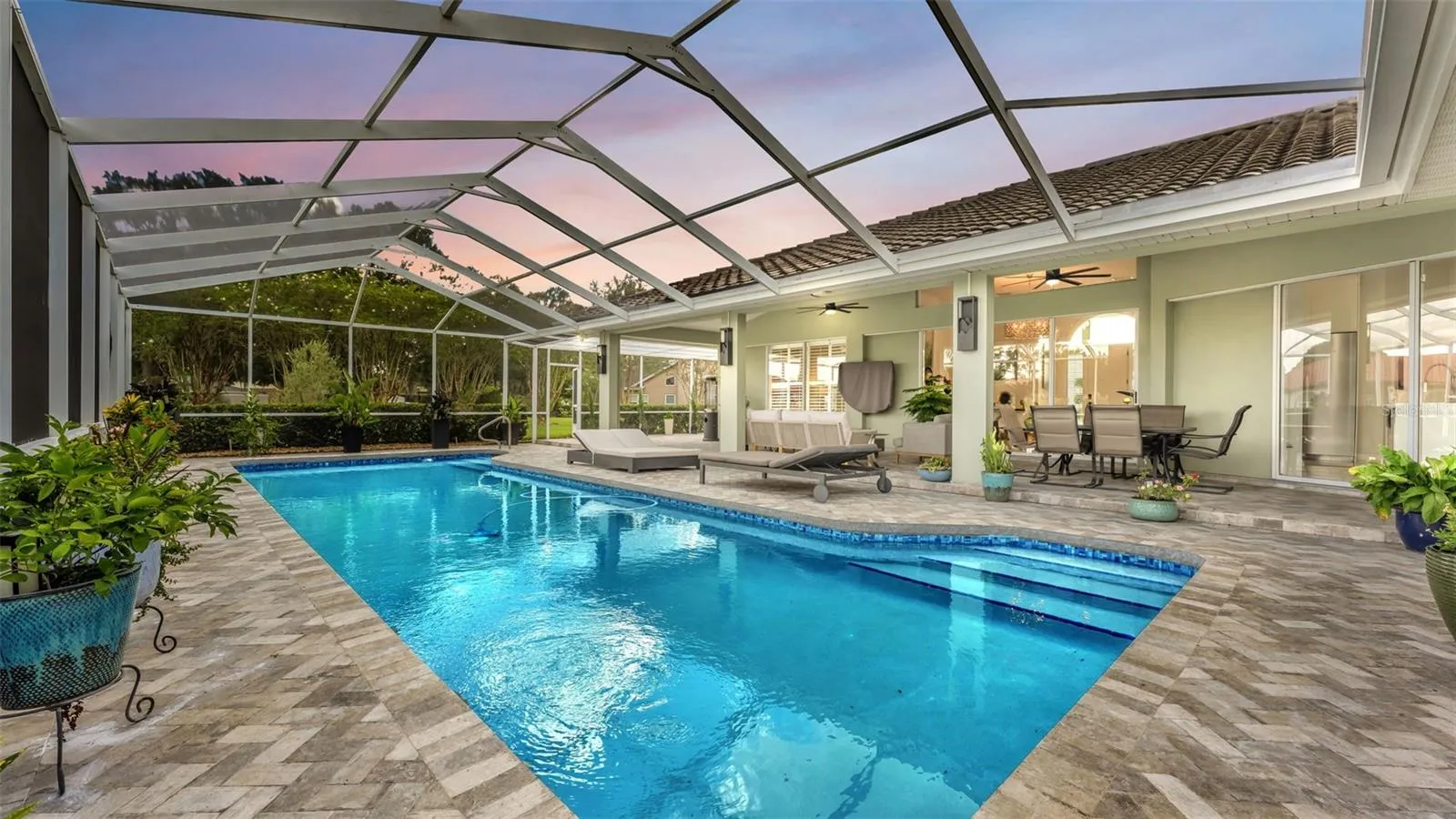 Gorgeous saltwater pool and lush landscaping create a relaxing retreat to enjoy.