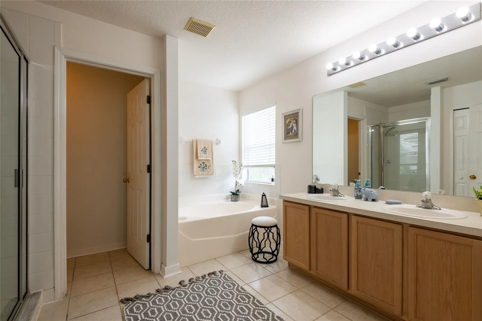 The owner bathroom features a garden tub, walk-in shower, dual vanities, and a large walk-in closet