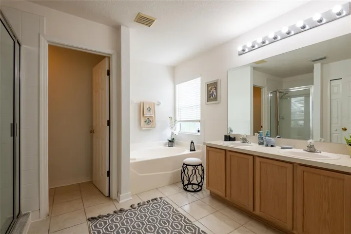 The owner bathroom features a garden tub, walk-in shower, dual vanities, and a large walk-in closet