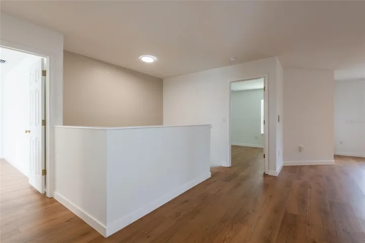 Upstairs loft separates the primary suite from the secondary bedrooms