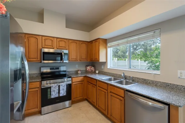 The well-appointed kitchen features granite countertops, stainless steel appliances, and a beautiful view to your back yard.