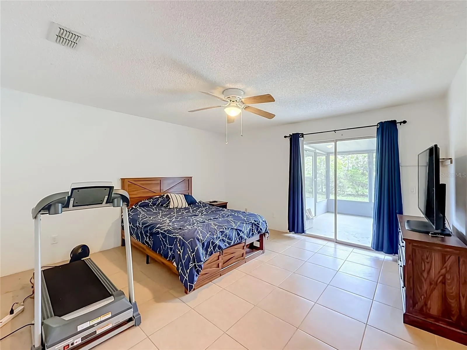 Very spacious primary bedroom with direct access to the lanai, creating a seamless connection to the outdoor living space.