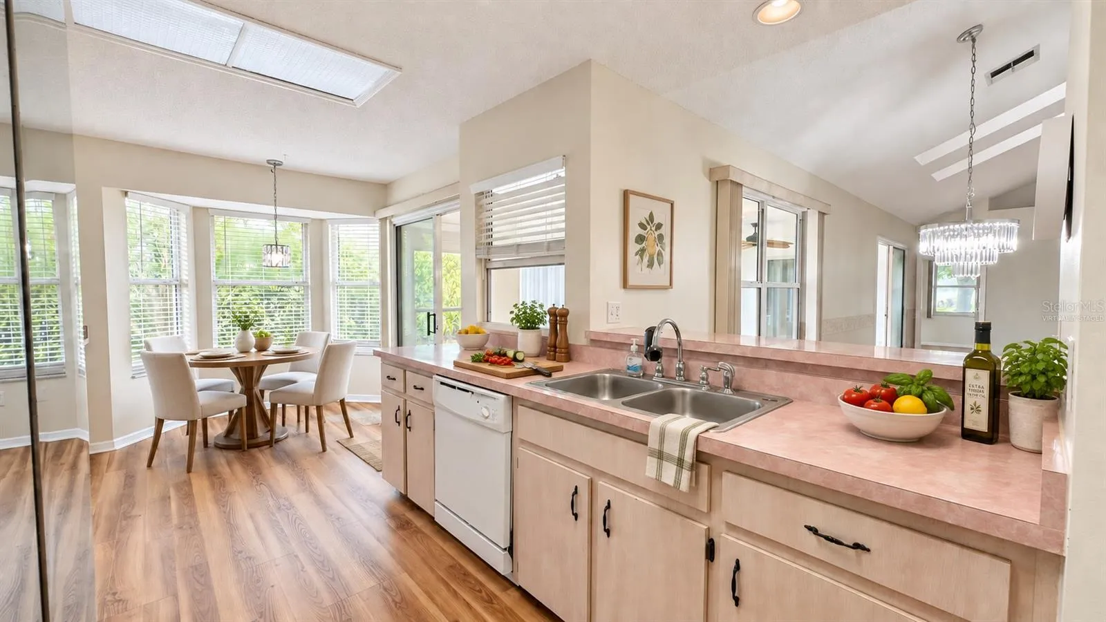 Large kitchen with breakfast room facing the backyard. Virtually staged.
