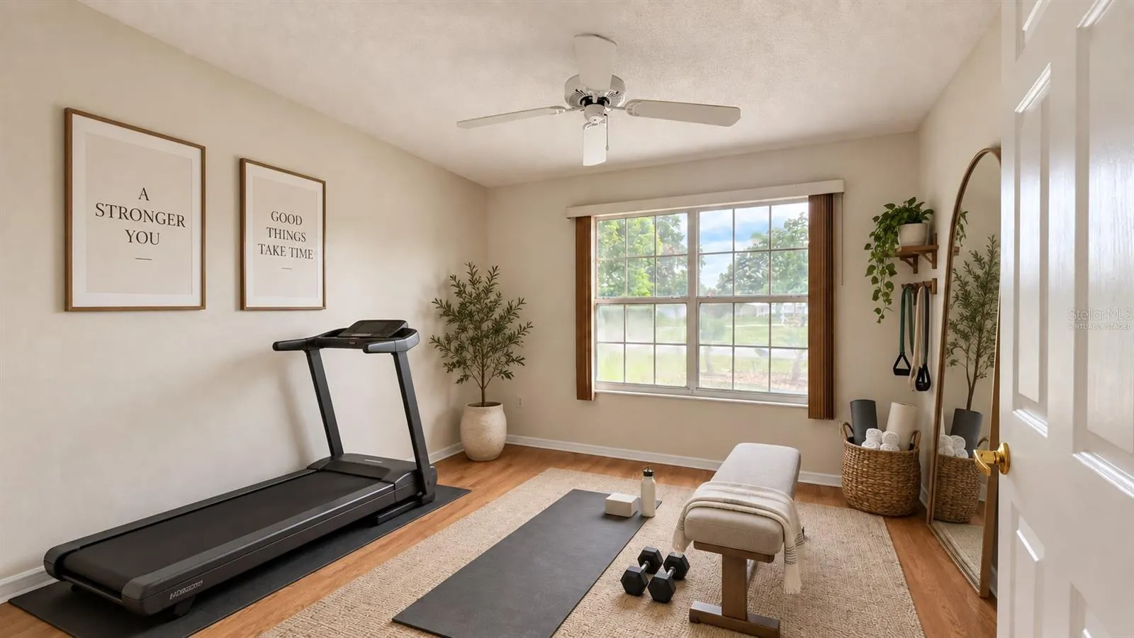 2 of 3 total bedrooms. Virtually staged as a home gym here.