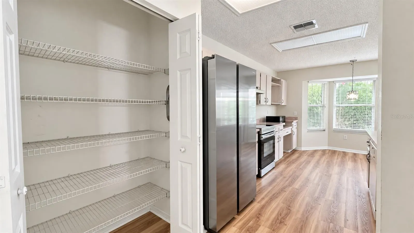 Spacious pantry in the large kitchen facing the enclosed lanai and backyard.