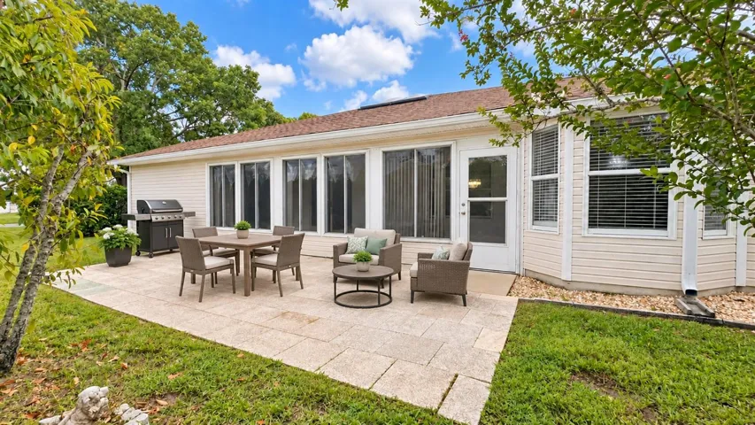 Large back patio with plenty of space to entertain and privacy. Virtually staged.