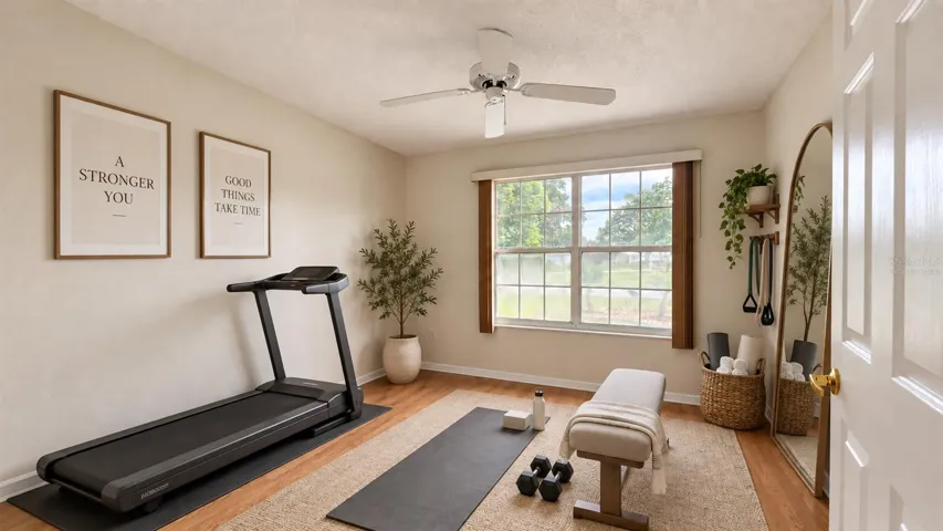 2 of 3 total bedrooms. Virtually staged as a home gym here.