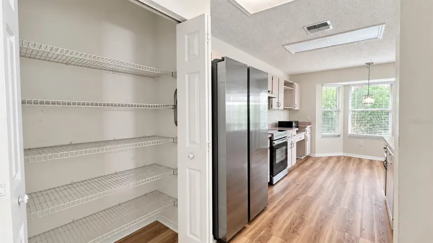 Spacious pantry in the large kitchen facing the enclosed lanai and backyard.