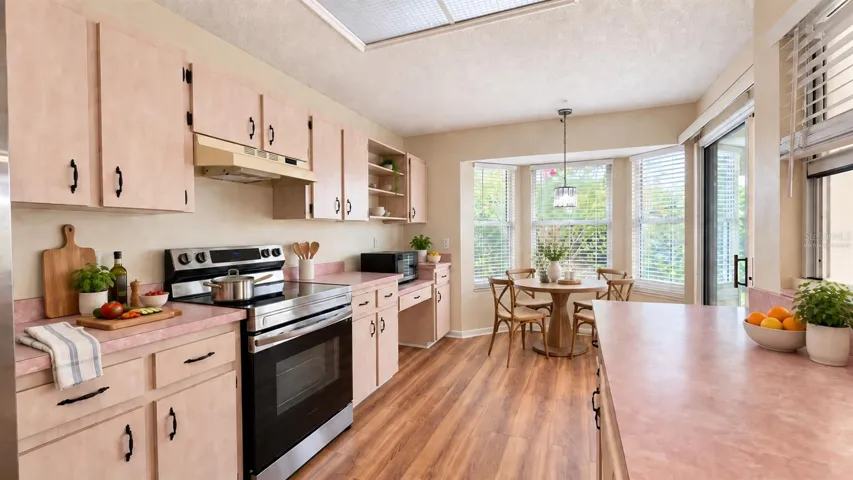Large kitchen with breakfast room facing the backyard. Virtually staged.