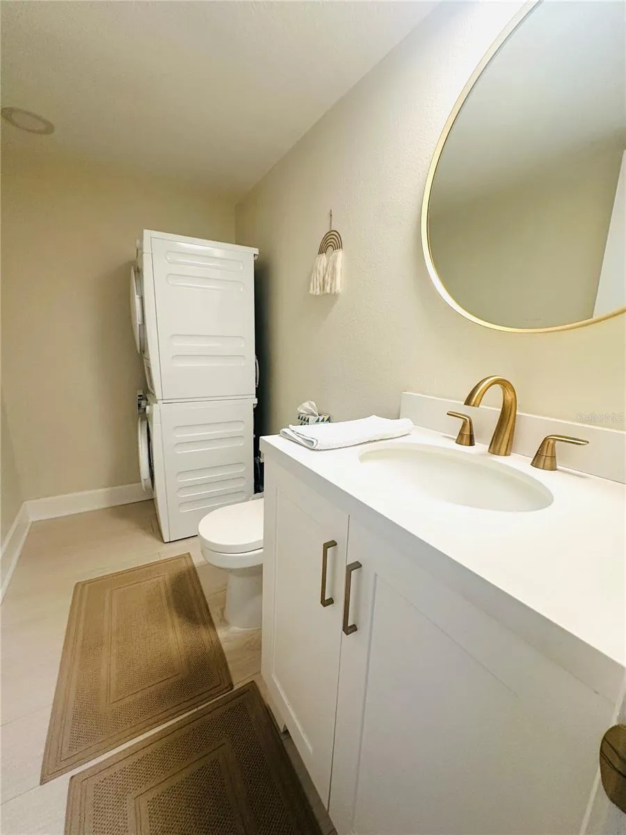 Half bathroom with washer and dryer