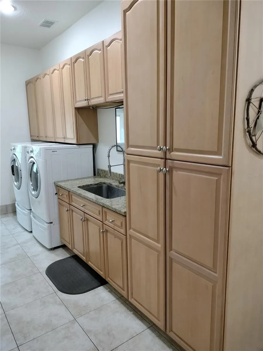 Washer, Gas Dryer, Sink, and Cabinets