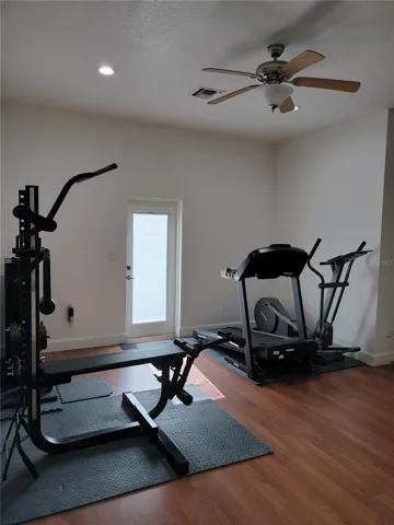 Gym with door to tennis court