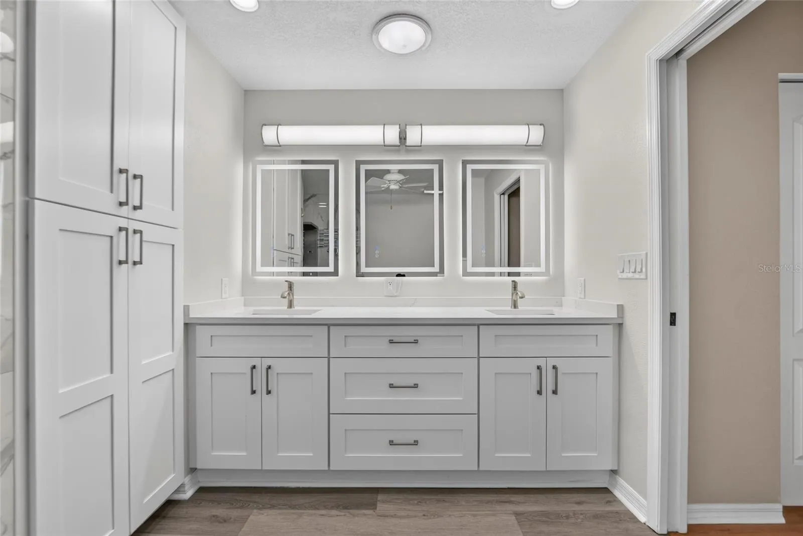 Double sinks, stunning lighting and extra-large linen closet