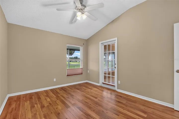 Guest bedroom w/ door leading to Florida room