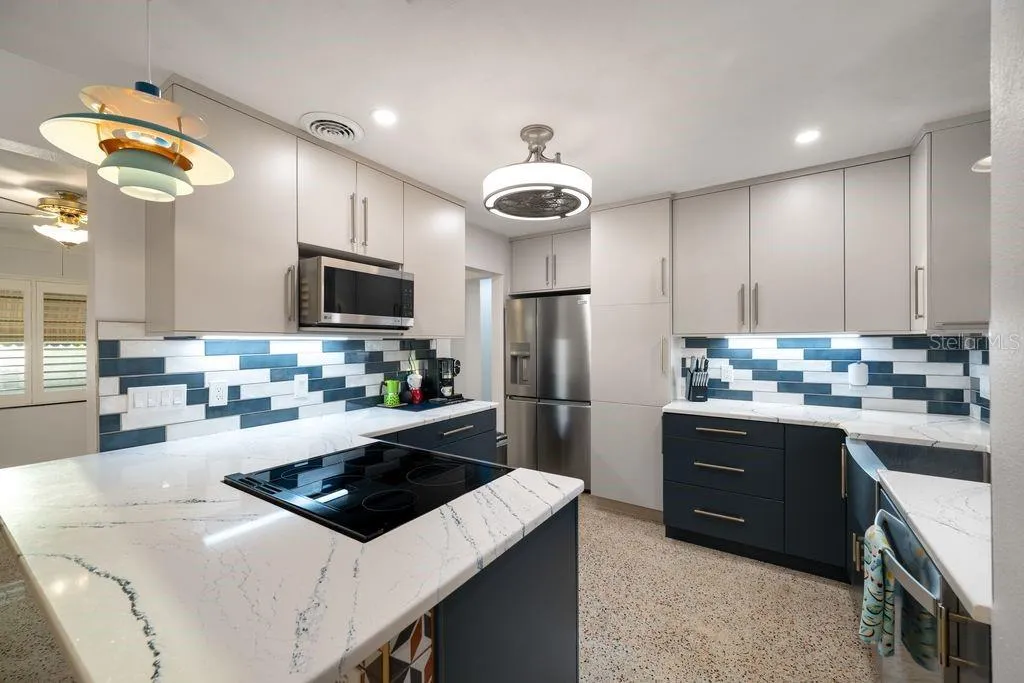 New Two Tone KitchenCraft Cabinets - Quartz Countertops and Pretty Tile Backsplash