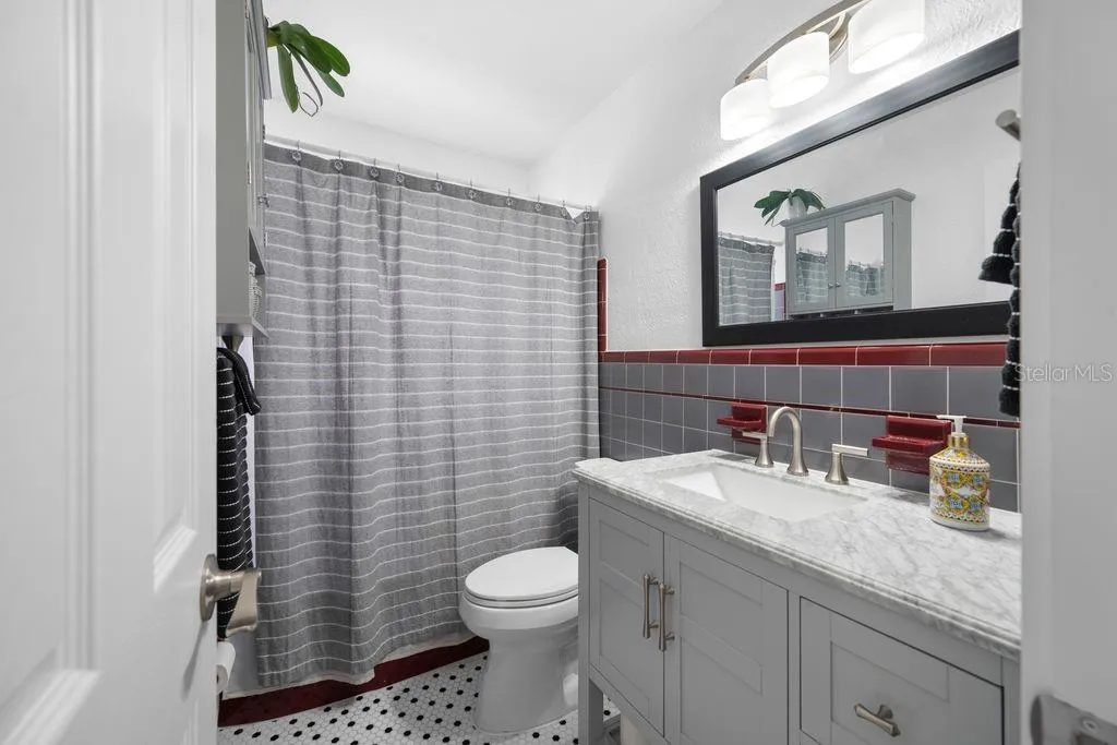 Retro Hall Bathroom with Updated Vanity, Mirror and Lighting