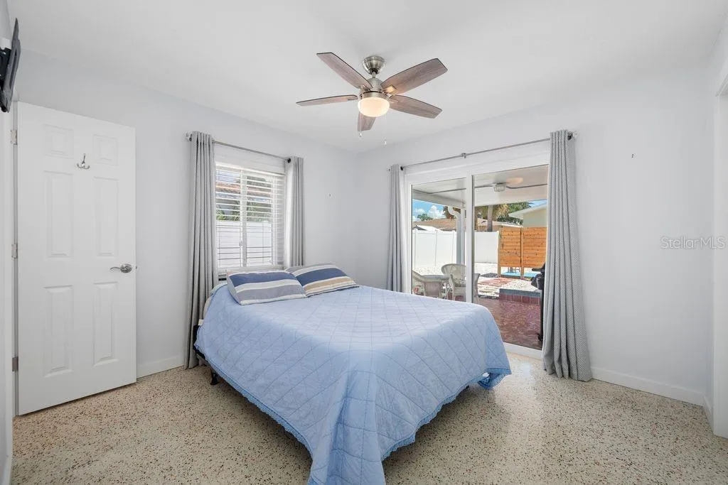Primary Bedroom with En-Suite Bathroom to the Left and Sliding Glass Door access to Lanai