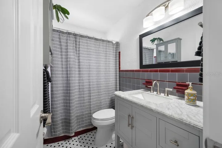 Retro Hall Bathroom with Updated Vanity, Mirror and Lighting