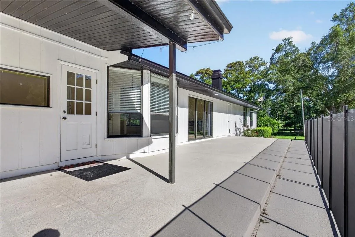Pool Deck with Back Door Entrance into Kitchen