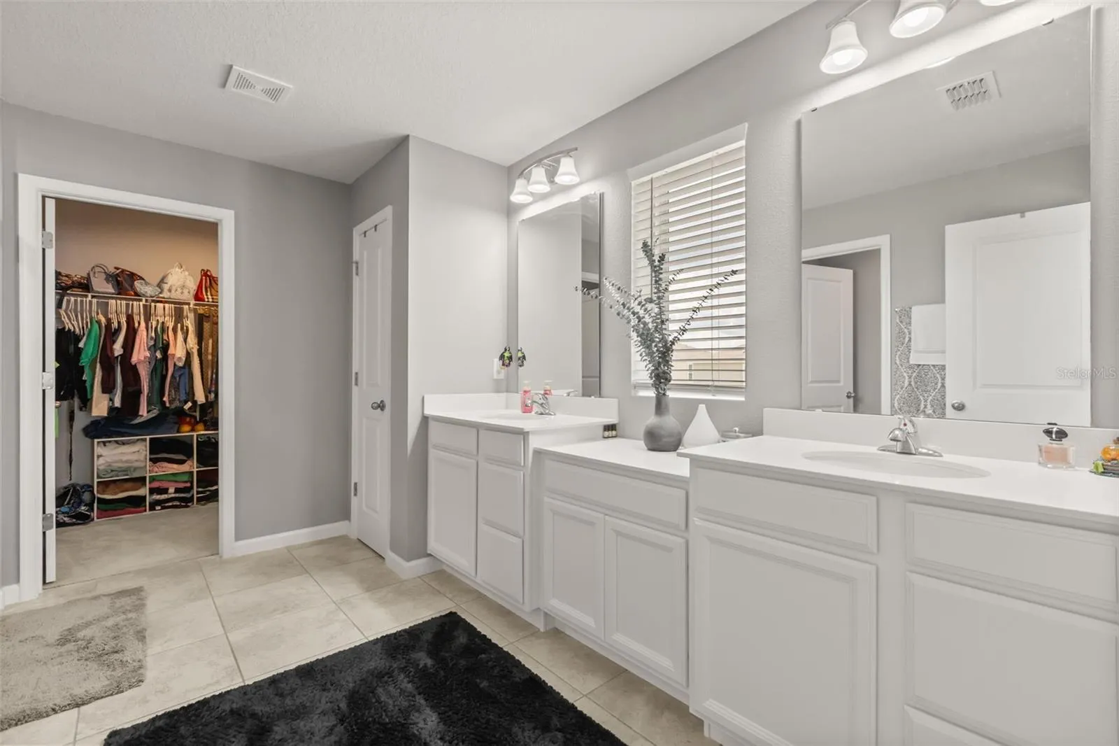 Primary bath with  double vanities, linen closet,  &amp; second walk-in closet.