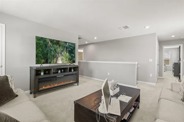Loft area with view to staircase &amp; hall to primary bedroom.