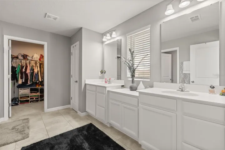 Primary bath with  double vanities, linen closet,  &amp; second walk-in closet.