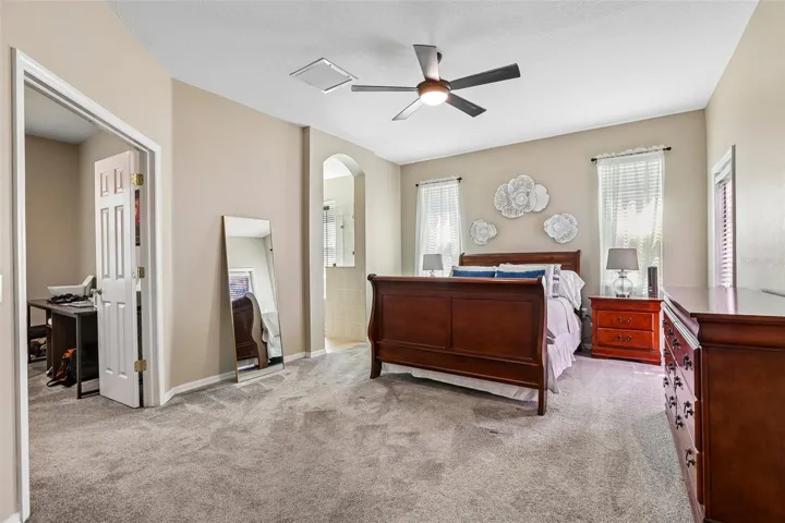 Primary Bedroom with view to Office and Primary Bathroom