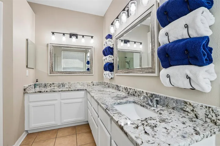 Primary Bathoom with beautiful granite and seam less shower glass