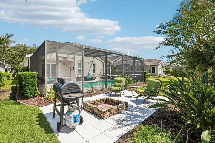 Rear view of home with fire pit and outdoor entertainment center