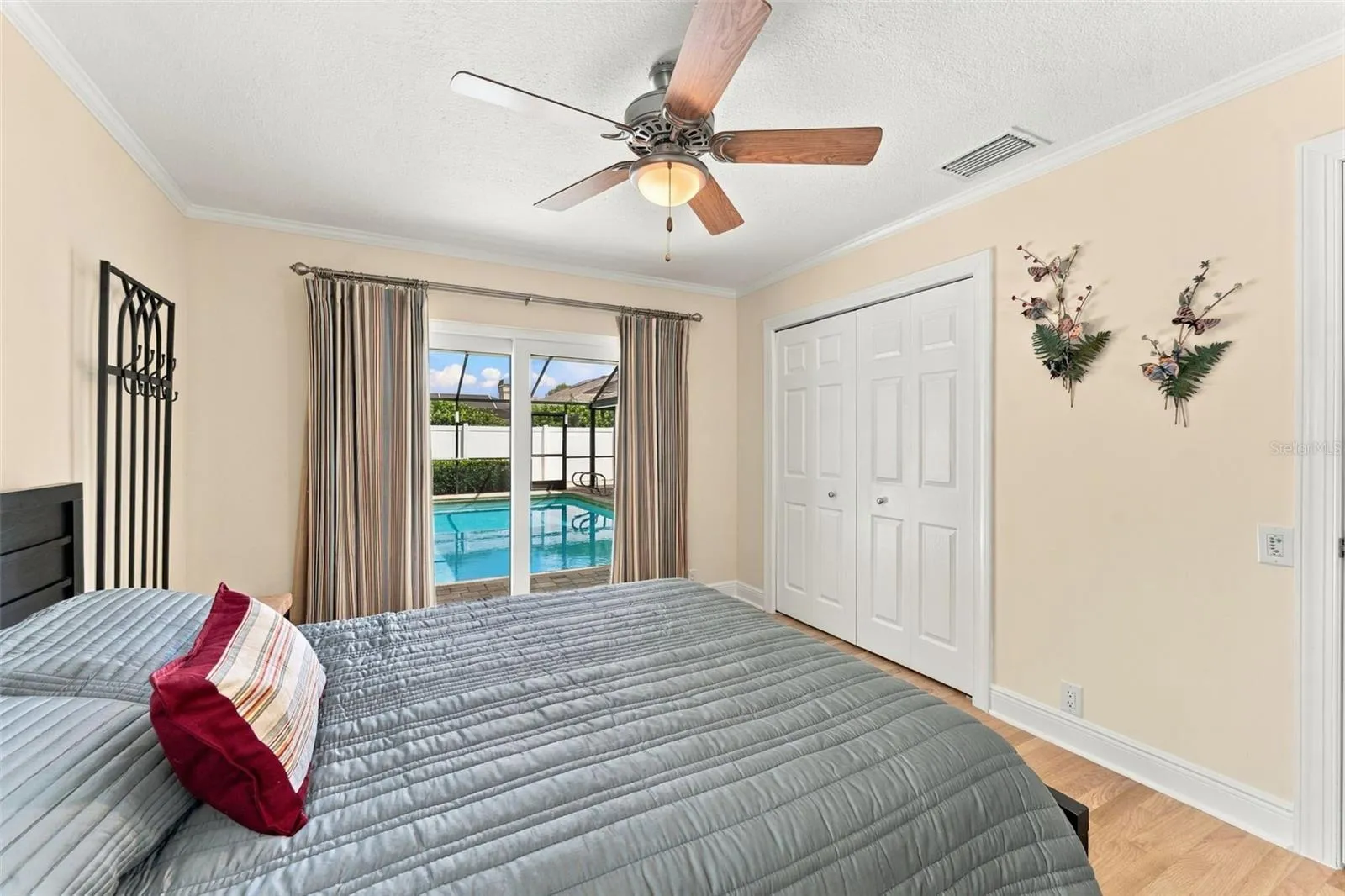 Bedroom 2 with sliding glass doors leading to pool area