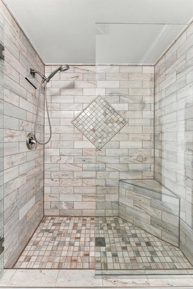 Beautifully Tiled Walk-In Shower with Built-In Bench & Glass Enclosure