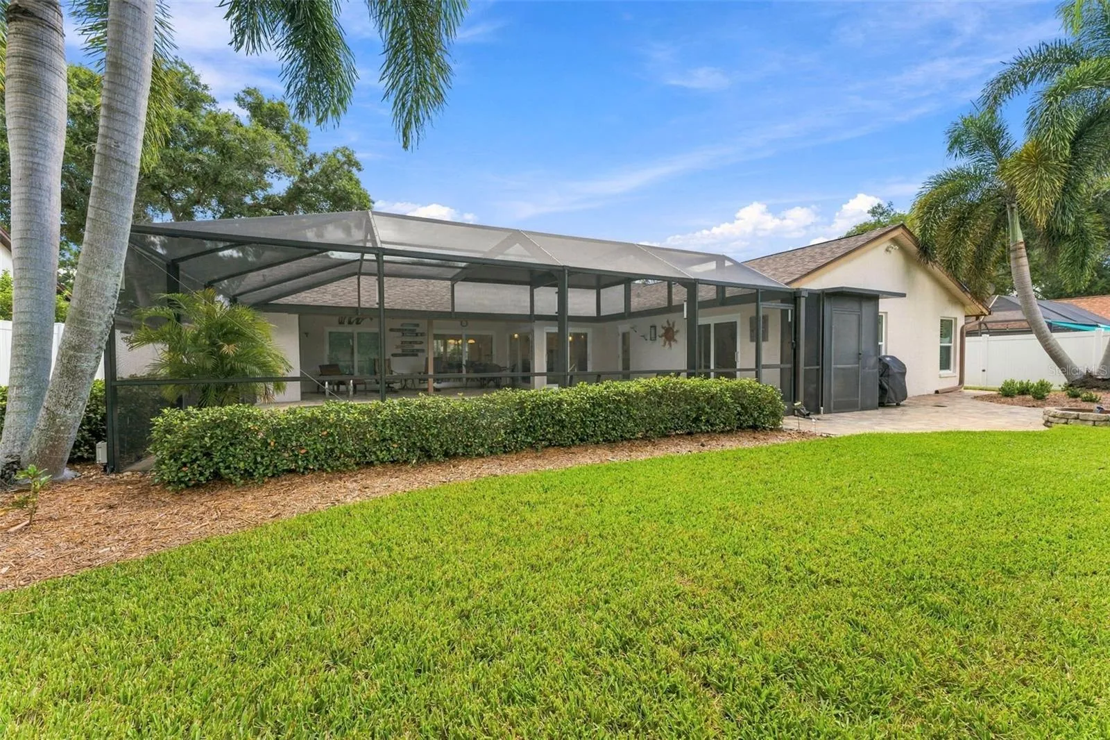 Backyard View of the Screened Pool Enclosure & Private Outdoor Retreat