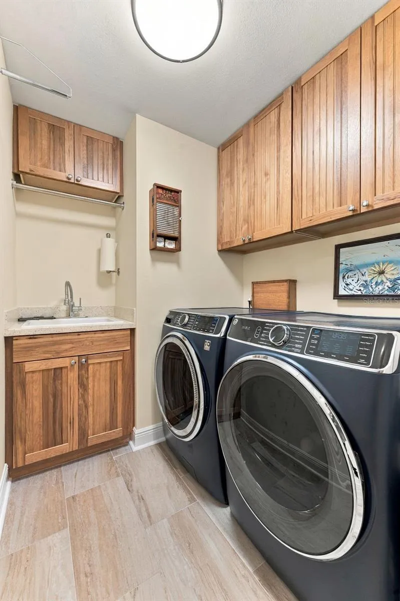 Well-Appointed Laundry Room with Extra Cabinet Storage & New High-End Washer and Dryer
