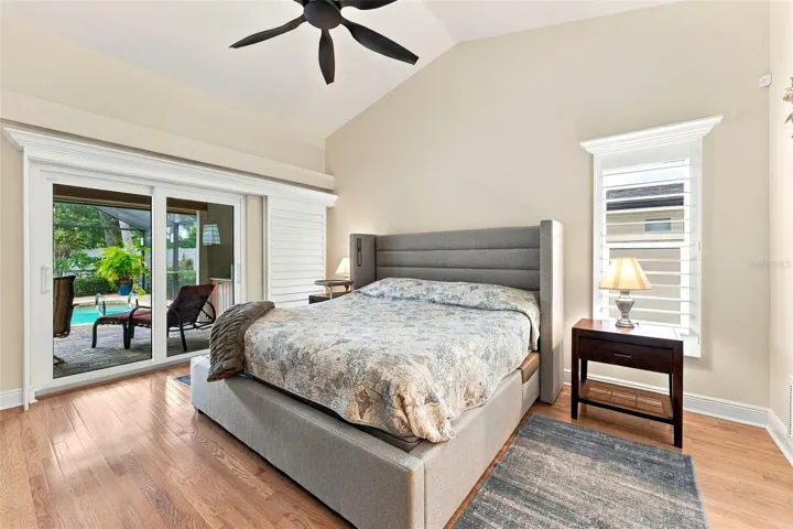 Primary Bedroom with Sliding Glass Doors Opening to the Pool Area