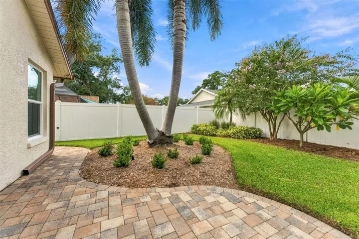Private Backyard Surrounded by a Six-Foot White Vinyl Fence