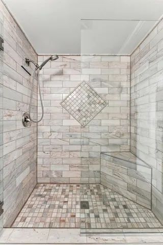 Beautifully Tiled Walk-In Shower with Built-In Bench & Glass Enclosure