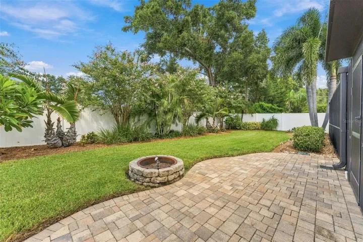 Beautifully Maintained Backyard with Paver Patio & Inviting Fire-Pit Area